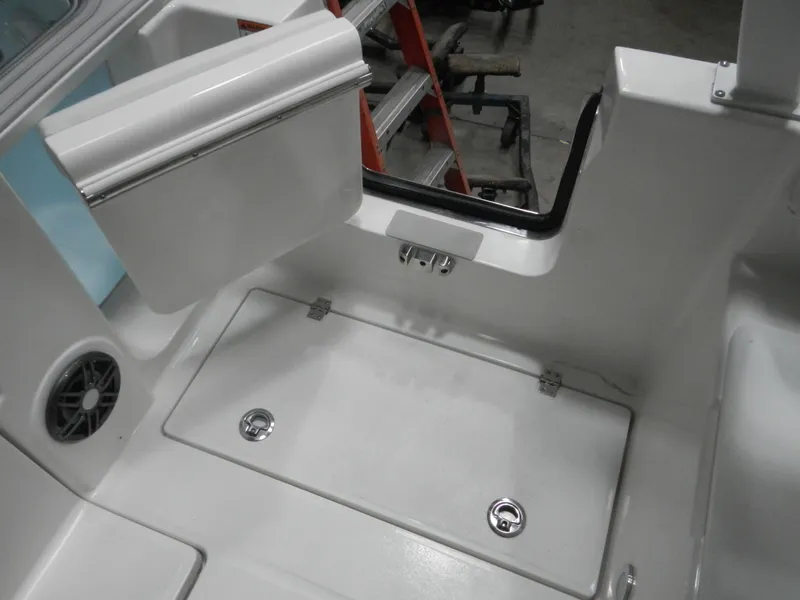 Slide: The Image of 2025 Sea Fox 268 Traveler boat interior, featuring storage compartment and speaker. - 9