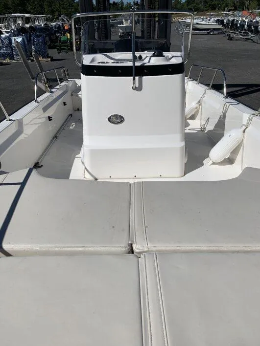 Slide: The Image of 2024 Boston Whaler 190 Montauk boat interior with cushioned seating and console. - 3