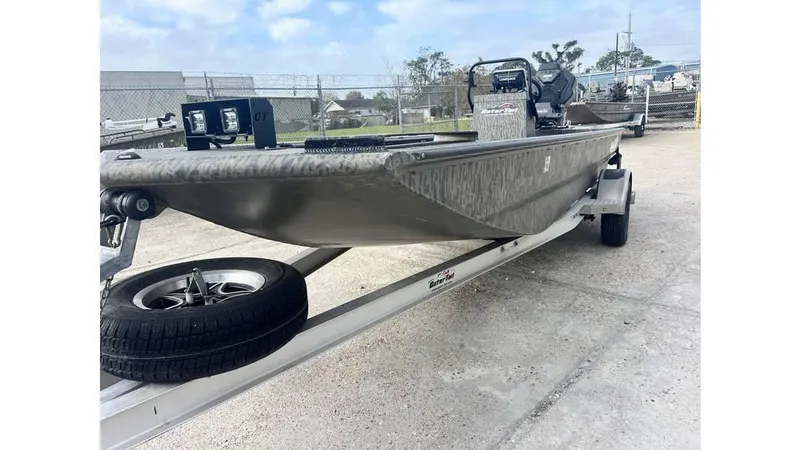 Slide: The Image of 2022 Gator Tail 1860 boat on trailer, parked outdoors. - 4