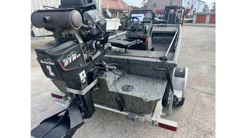 Slide: The Image of 2022 Gator Tail 1860 boat with motor, parked on concrete surface. - 5