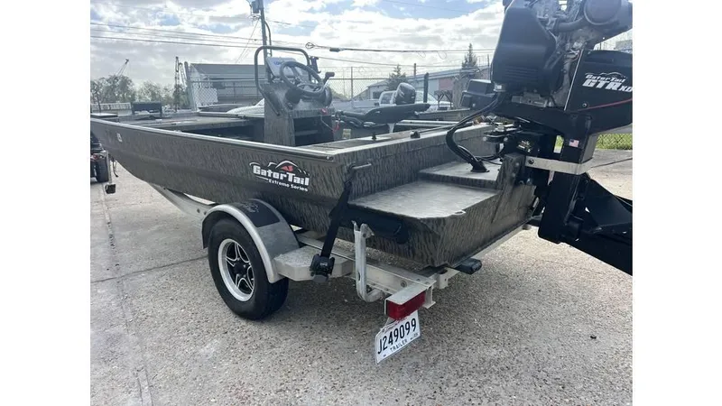 Slide: The Image of 2022 Gator Tail 1860 boat on trailer, outdoor setting, rear view. - 6