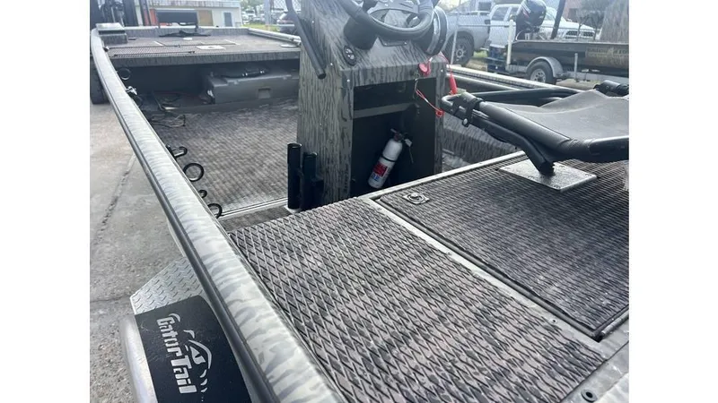 Slide: The Image of 2022 Gator Tail 1860 boat interior with steering wheel and storage compartment. - 7