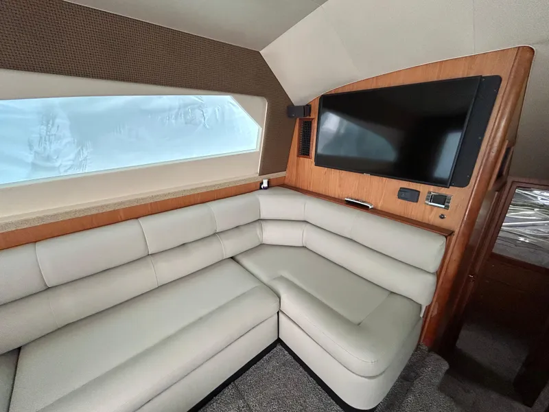 Slide: The Image of Interior of 2007 Luhrs 36 Convertible yacht with beige leather seating and mounted TV. - 14