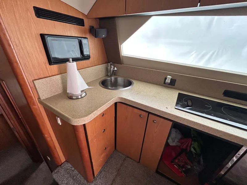 Slide: The Image of 2007 Luhrs 36 Convertible yacht kitchen with sink, microwave, and stovetop. - 15