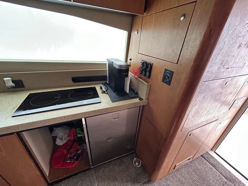 Slide: The Image of 2007 Luhrs 36 Convertible yacht kitchen with stove, fridge, and coffee maker. - 16