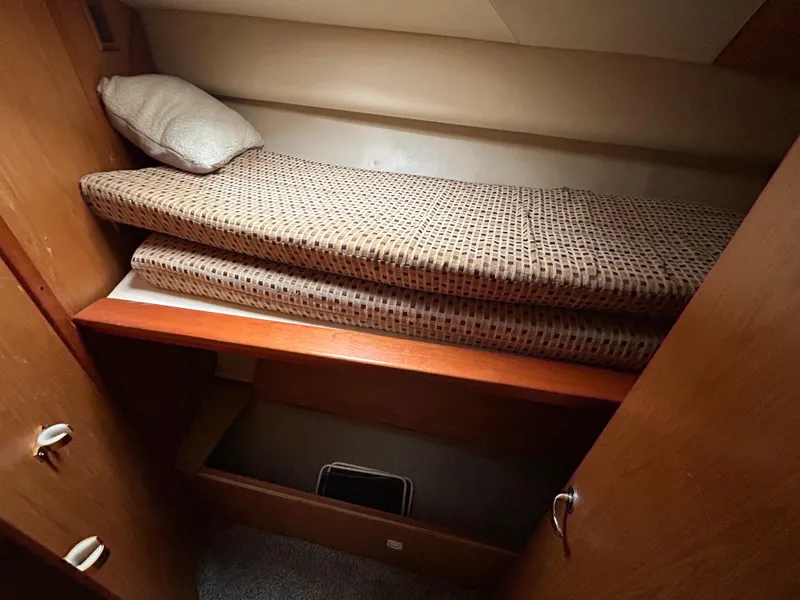Slide: The Image of 2007 Luhrs 36 Convertible cabin interior with bunk bed and storage space. - 18