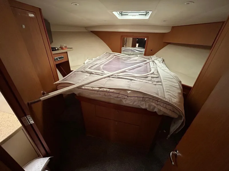 Slide: The Image of Interior cabin of 2007 Luhrs 36 Convertible boat with bed and wooden cabinetry. - 19