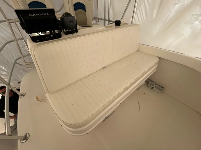 Slide: The Image of 2007 Luhrs 36 Convertible boat interior with white cushioned seating and Garmin equipment. - 6