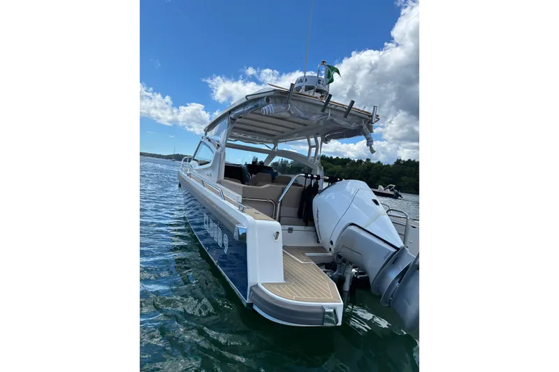 Slide: The Image of 2023 Nimbus W9 boat on water, featuring sleek design and powerful outboard motor. - 15