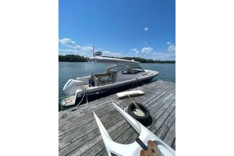 Slide: The Image of 2023 Nimbus W9 boat docked on a wooden pier under a clear blue sky. - 5