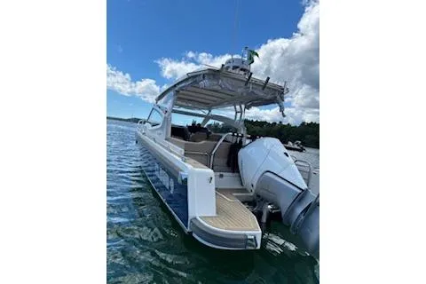 Slide: The Image of 2023 Nimbus W9 boat on water, clear sky, modern design, outboard motor. - 7