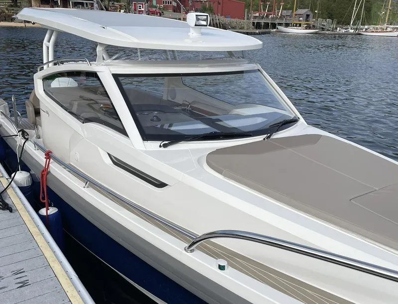 Slide: The Image of 2023 Nimbus W9 boat docked at a marina, featuring sleek design and modern amenities. - 9