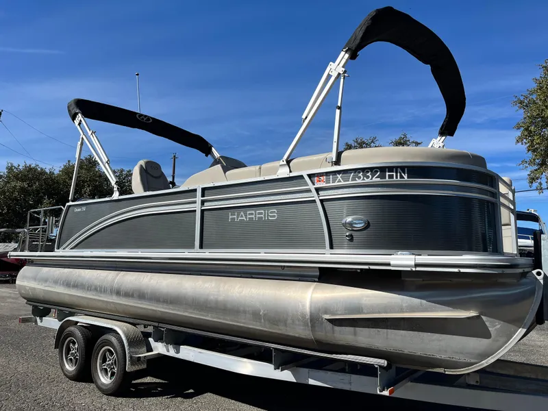 Slide: The Image of 2020 Harris FloteBote Cruiser 230 pontoon boat on trailer, sunny day. - 1
