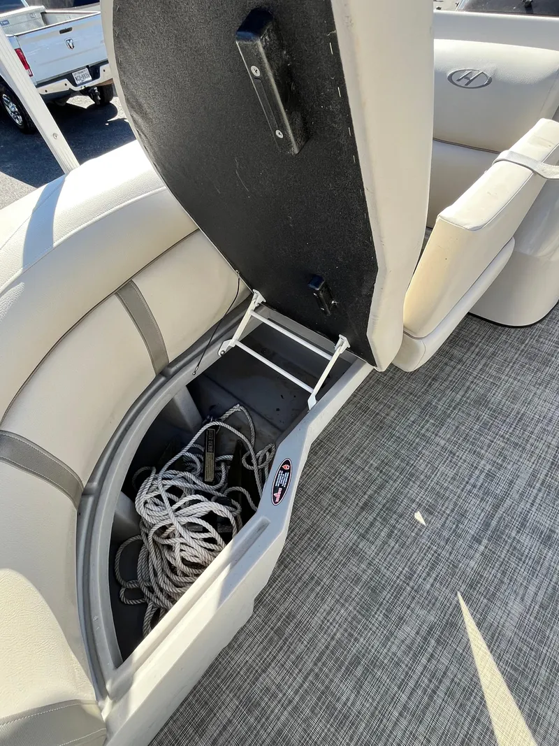 Slide: The Image of 2020 Harris FloteBote Cruiser 230 boat seat storage with rope inside. - 11
