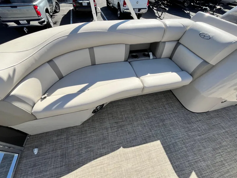 Slide: The Image of 2020 Harris FloteBote Cruiser 230 interior seating with beige upholstery and carpeted flooring. - 15