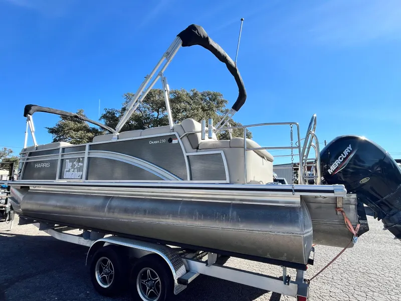 Slide: The Image of 2020 Harris FloteBote Cruiser 230 pontoon boat on trailer, sunny day. - 2