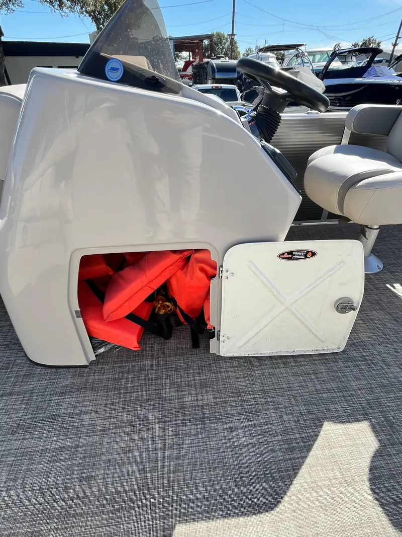 Slide: The Image of 2020 Harris FloteBote Cruiser 230 storage compartment with life jackets. - 20