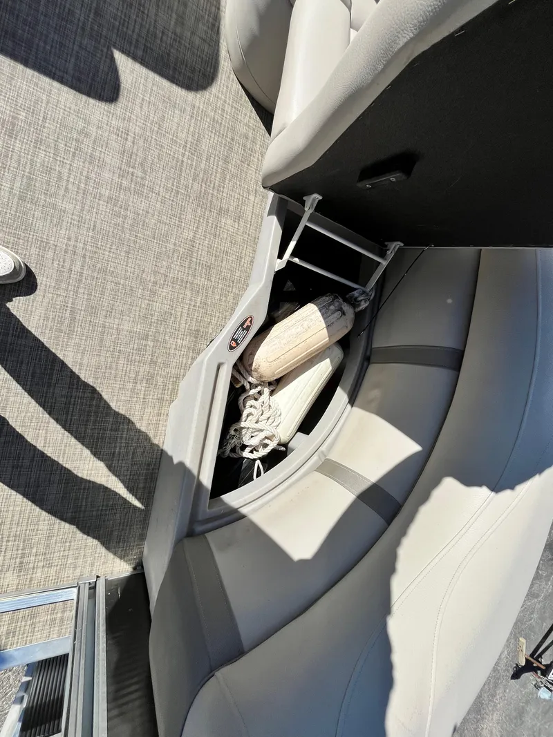 Slide: The Image of 2020 Harris FloteBote Cruiser 230 interior storage with ropes and fenders. - 22