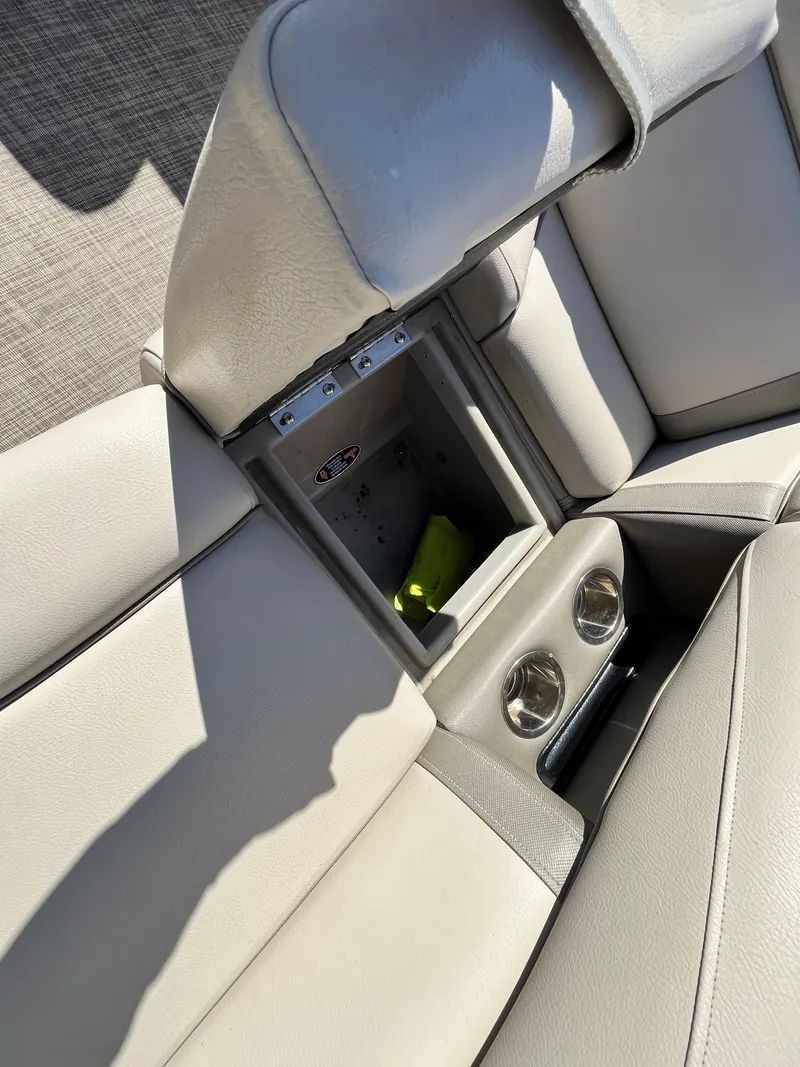 Slide: The Image of 2020 Harris FloteBote Cruiser 230 interior with open storage compartment and cup holders. - 24