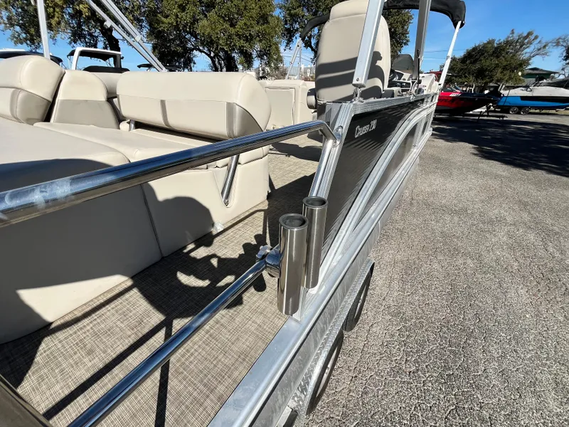 Slide: The Image of 2020 Harris FloteBote Cruiser 230 pontoon boat with beige seating and stainless steel railings. - 30