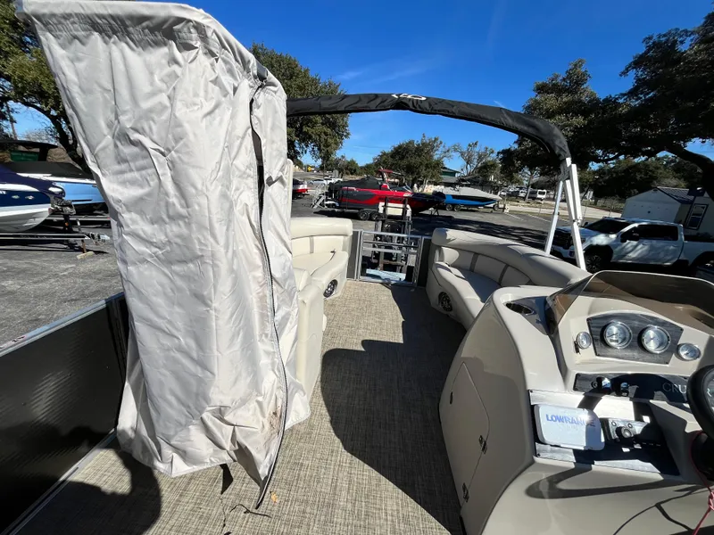 Slide: The Image of 2020 Harris FloteBote Cruiser 230 pontoon boat interior with canopy and dashboard. - 5