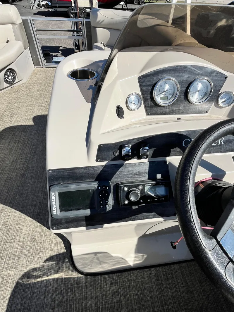 Slide: The Image of Dashboard of a 2020 Harris FloteBote Cruiser 230 pontoon boat with steering wheel and gauges. - 6