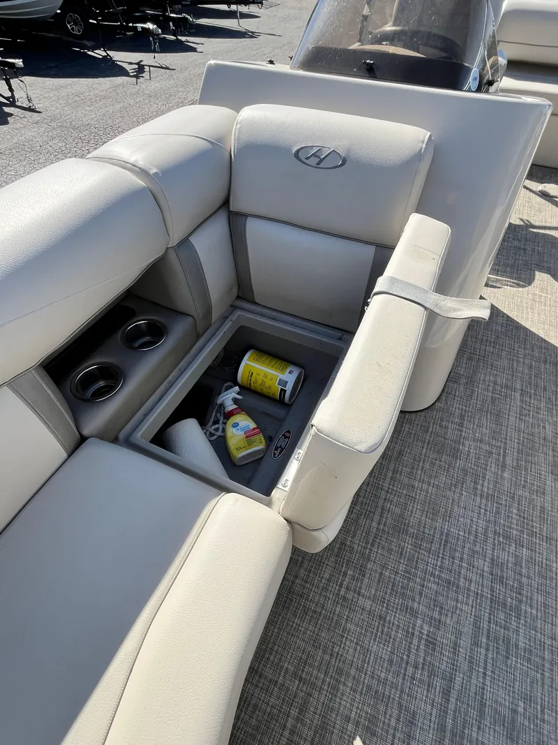 Slide: The Image of 2020 Harris FloteBote Cruiser 230 interior with storage compartment and cup holders. - 8