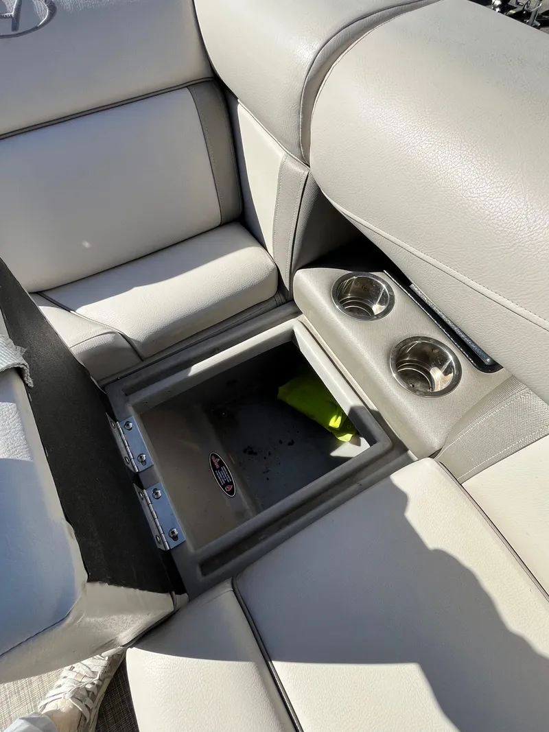 Slide: The Image of 2020 Harris FloteBote Cruiser 230 interior with storage compartment and cup holders. - 9