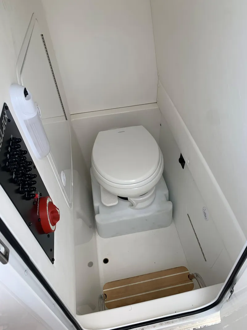 Slide: The Image of 2021 Regulator 26XO boat interior with compact marine toilet. - 5