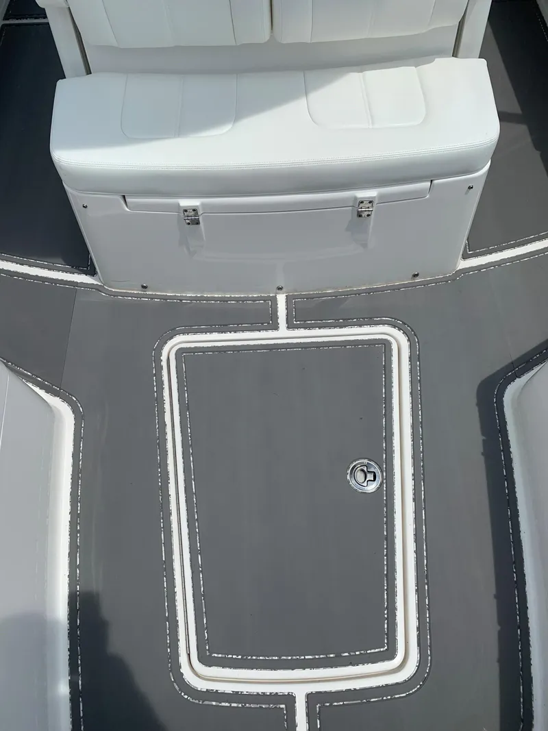 Slide: The Image of 2021 Regulator 26XO boat interior with white seating and gray deck. - 7