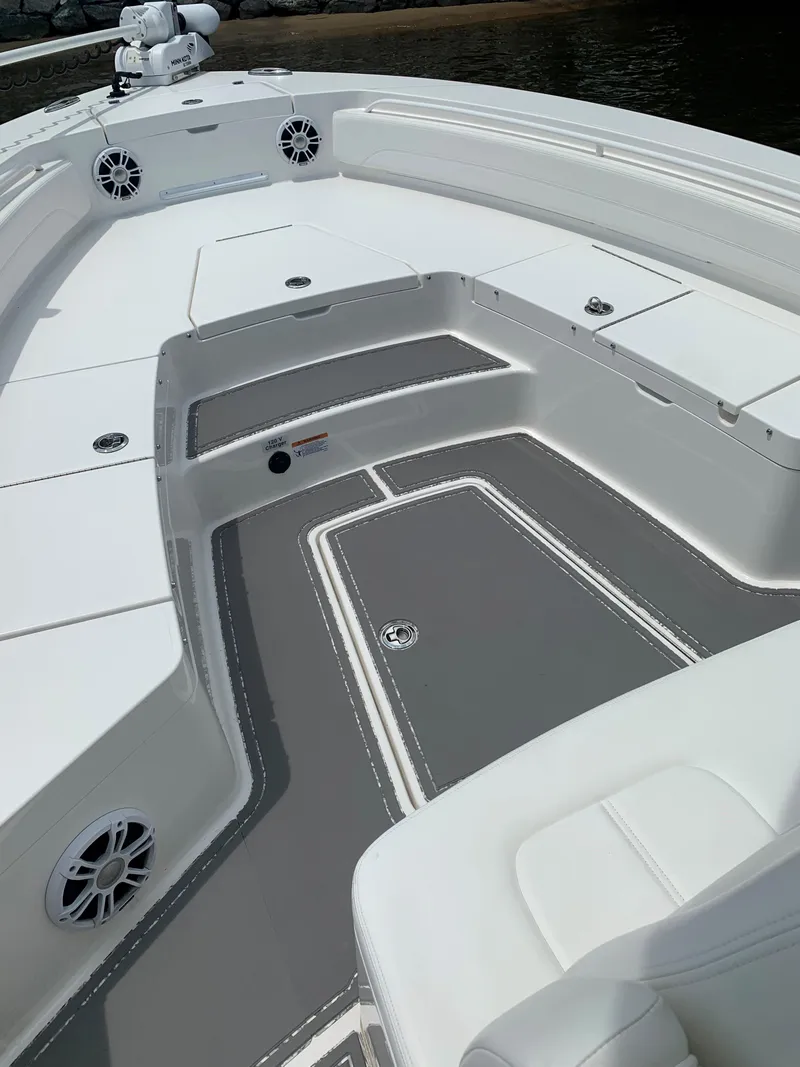 Slide: The Image of 2021 Regulator 26XO boat interior with white seating and gray flooring. - 8
