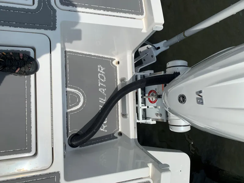 Slide: The Image of 2021 Regulator 26XO boat deck with Yamaha outboard motor and foot visible. - 9