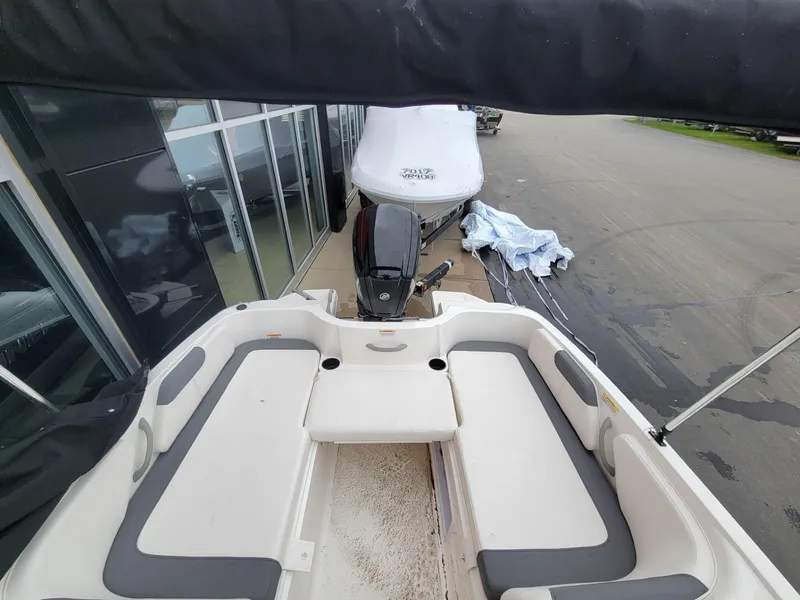 Slide: The Image of 2025 Bayliner Element E18 boat interior with seating and motor view. - 11
