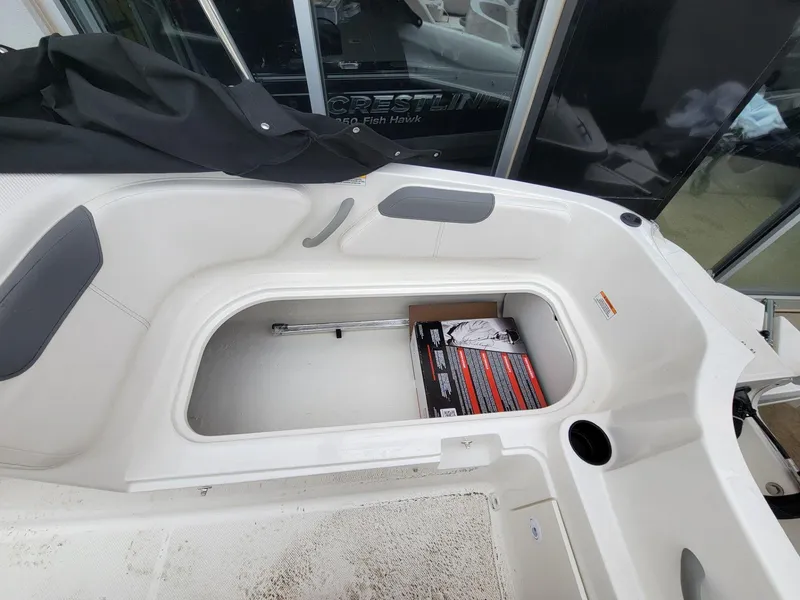 Slide: The Image of 2025 Bayliner Element E18 boat interior storage compartment with open hatch. - 12