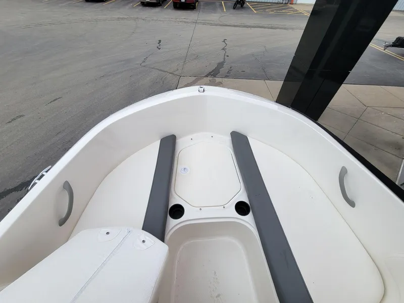 Slide: The Image of 2025 Bayliner Element E18 boat interior with seating and cup holders. - 18
