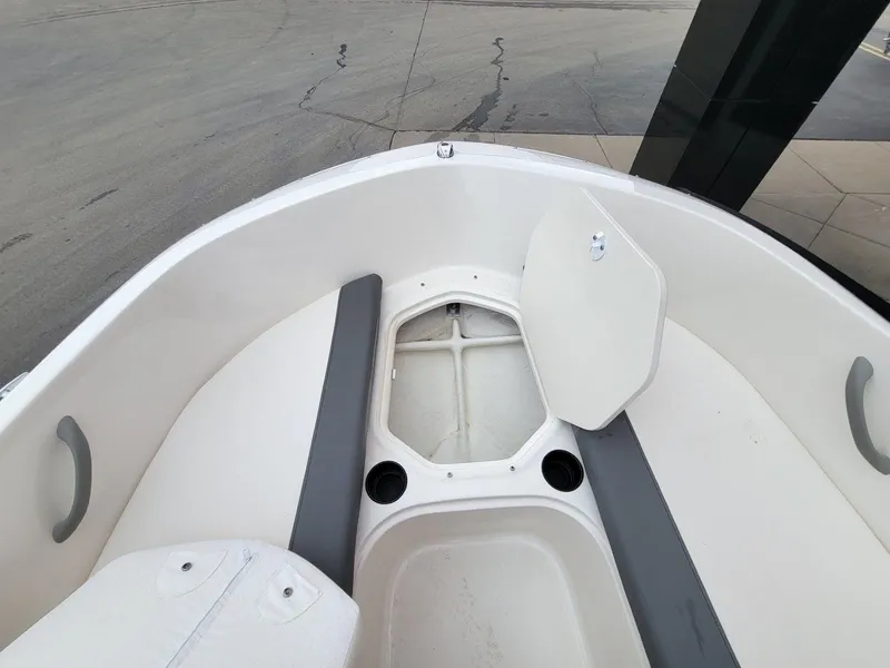 Slide: The Image of 2025 Bayliner Element E18 boat interior with open storage compartment and seating. - 19