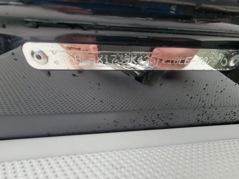 Slide: The Image of 2025 Bayliner Element E18 boat identification number plate with water droplets. - 21