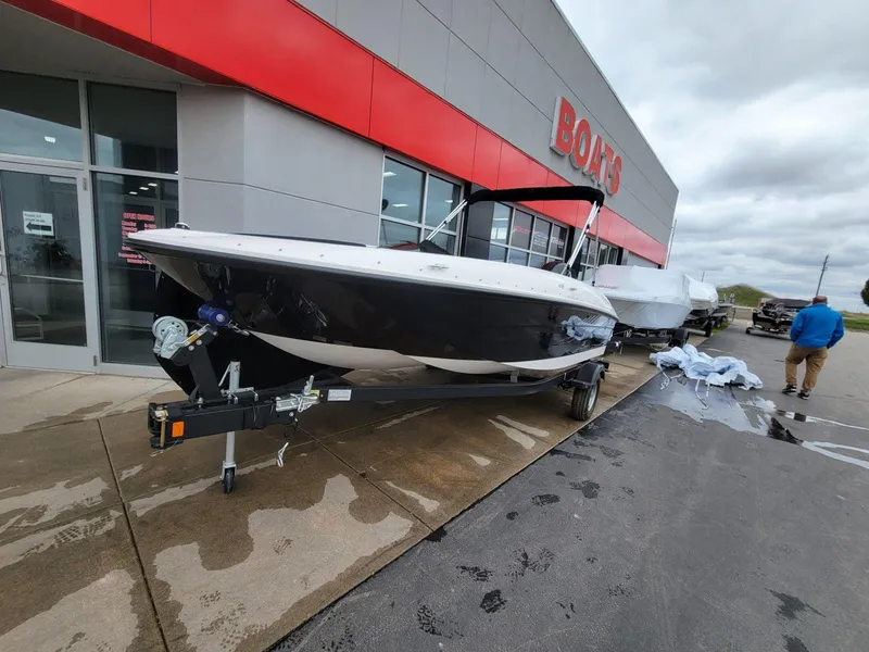 Slide: The Image of 2025 Bayliner Element E18 boat displayed outside a dealership under cloudy skies. - 3