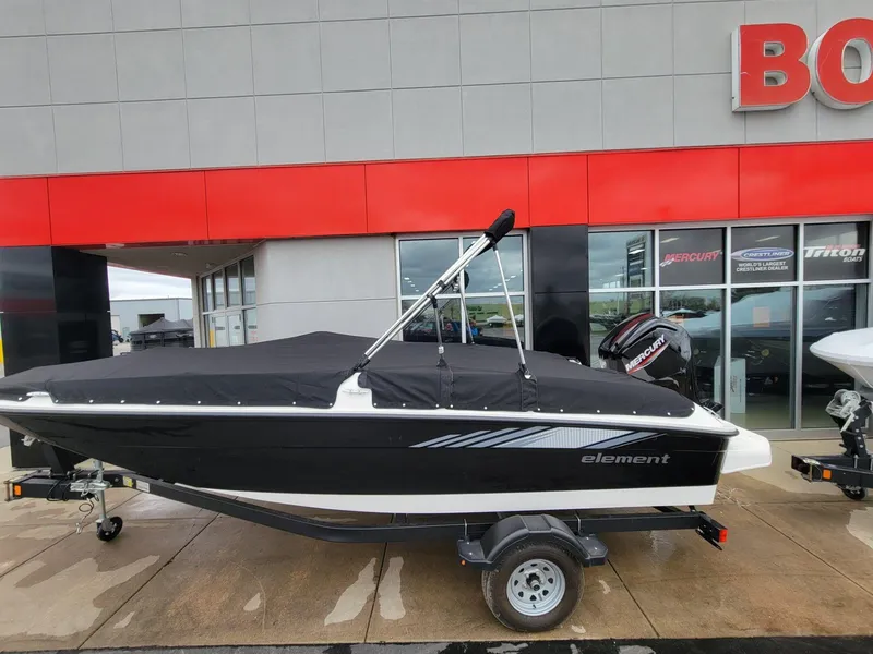 Slide: The Image of 2025 Bayliner Element E18 boat with cover, parked outside dealership. - 5