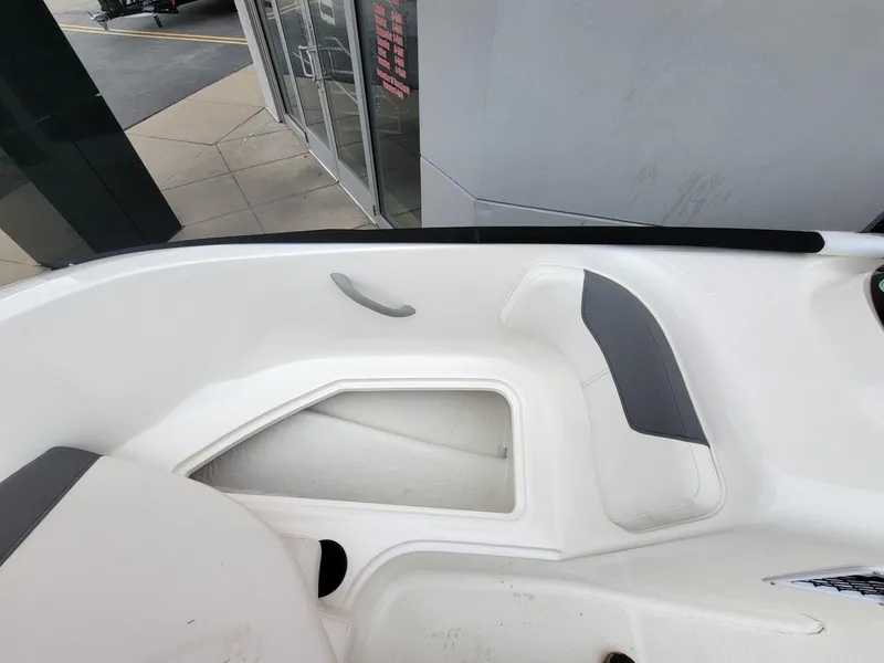 Slide: The Image of 2025 Bayliner Element E18 boat interior with white and gray seating. - 8