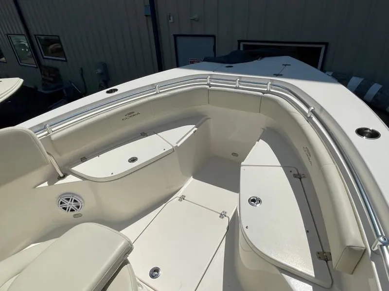 Slide: The Image of 2023 Cobia 237 CC boat interior with cushioned seating and storage compartments. - 2
