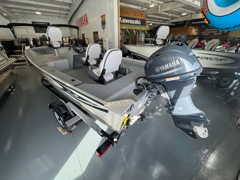 Slide: The Image of 2025 Starcraft Patriot 16 SC boat with Yamaha motor in showroom. - 2