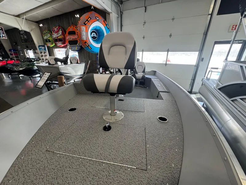 Slide: The Image of 2025 Starcraft Patriot 16 SC boat interior with seating in showroom. - 4