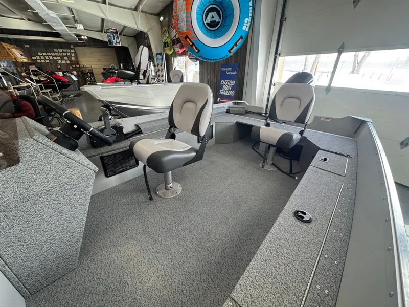 Slide: The Image of 2025 Starcraft Patriot 16 SC boat interior with seating and control panel. - 5