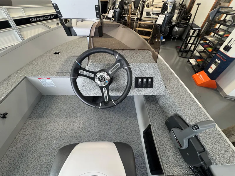 Slide: The Image of 2025 Starcraft Patriot 16 SC boat interior with steering wheel and control panel. - 6