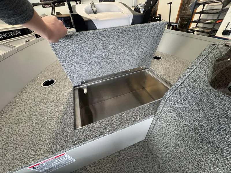 Slide: The Image of 2025 Starcraft Patriot 16 SC boat interior with open storage compartment. - 7