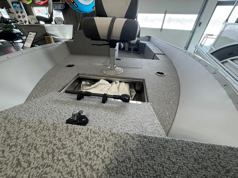 Slide: The Image of 2025 Starcraft Patriot 16 SC boat interior with storage compartment and seating. - 8