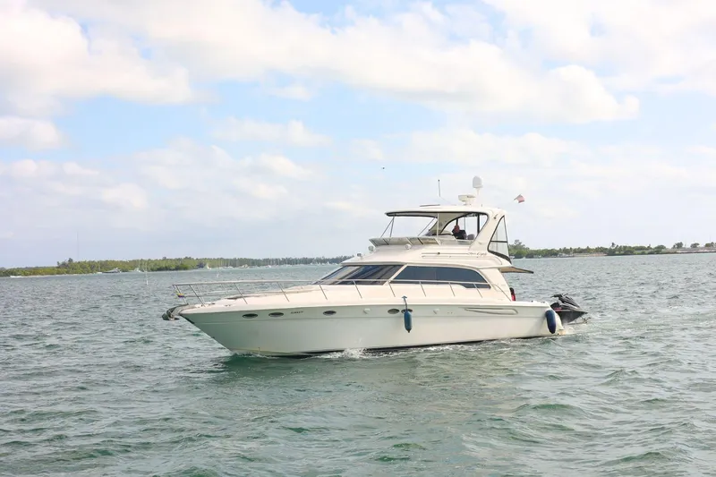 Slide: The Image of 2000 Sea Ray 480 Sedan Bridge yacht cruising on open water. - 1