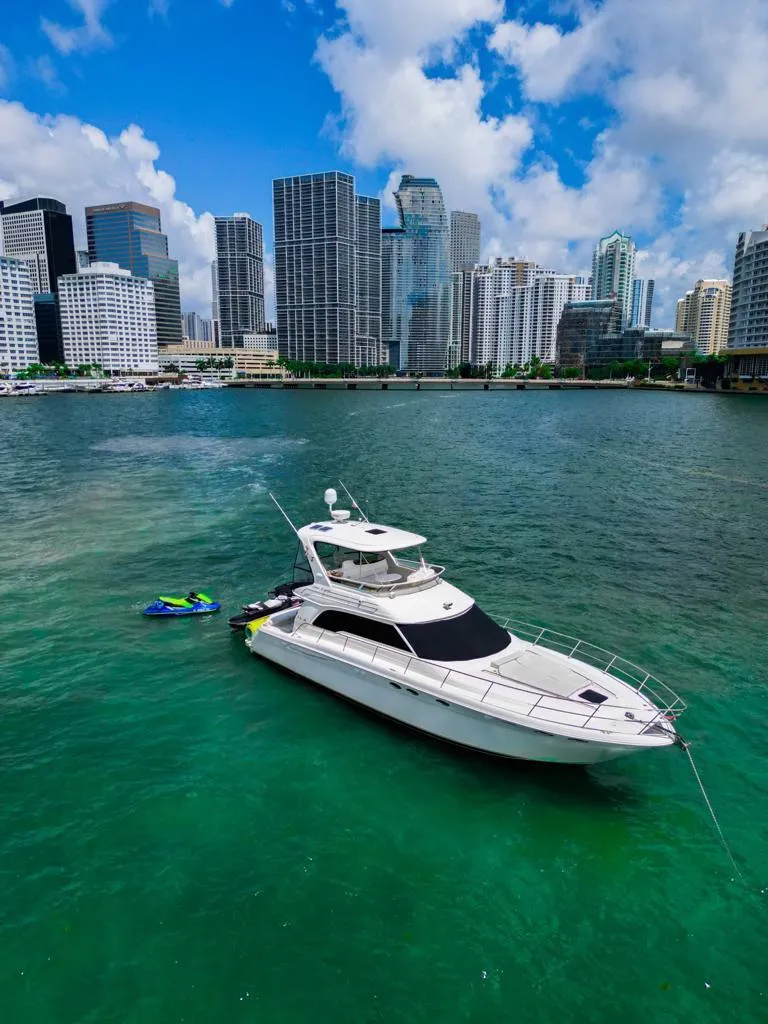 Slide: The Image of 2000 Sea Ray 480 Sedan Bridge yacht in vibrant city waterfront setting. - 14