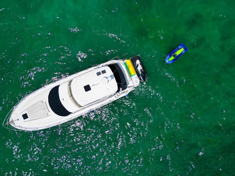 Slide: The Image of Aerial view of 2000 Sea Ray 480 Sedan Bridge yacht on green water. - 18